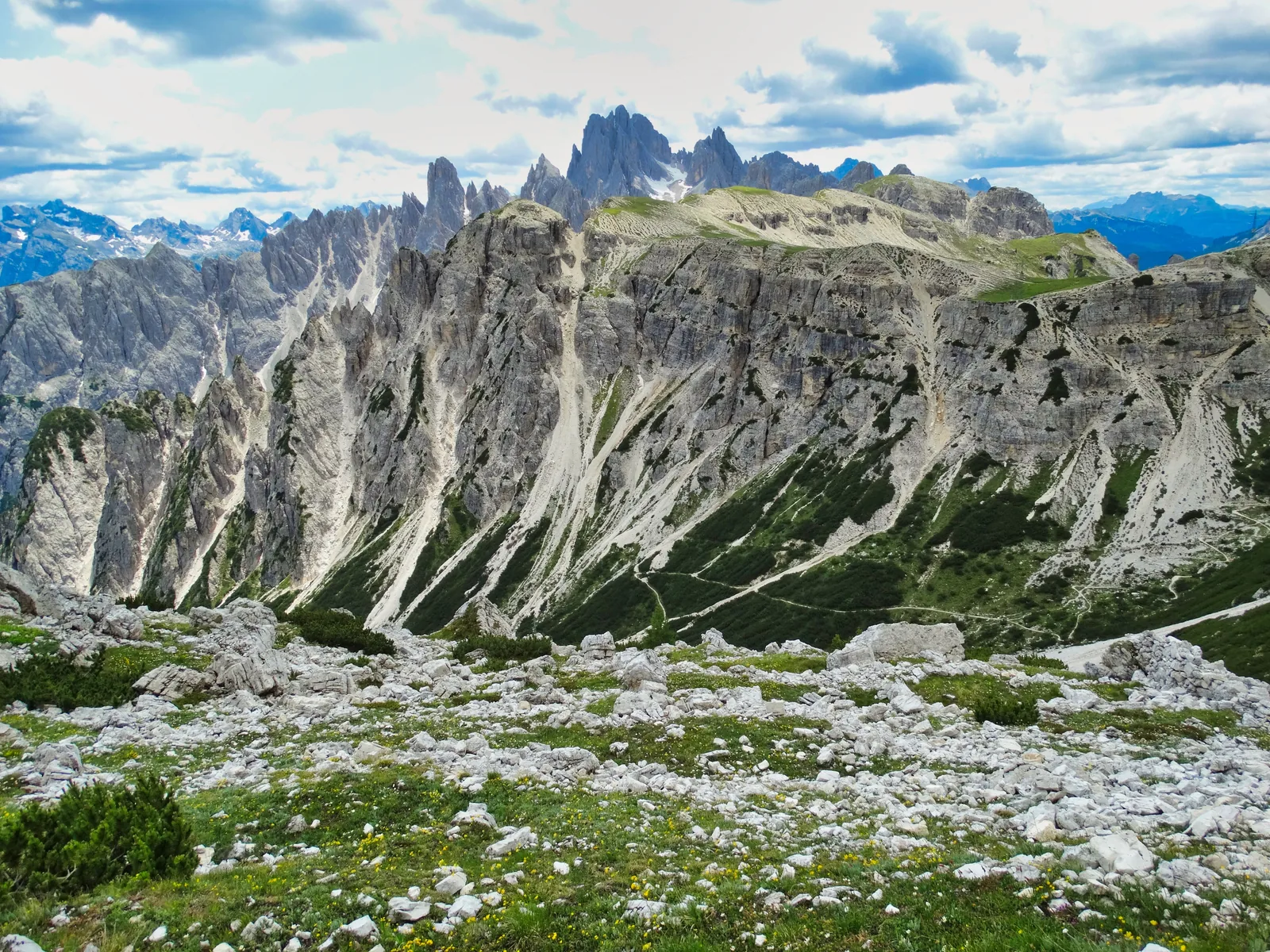The Tre Cime di Lavaredo peaks rising above green alpine meadows in the Dolomites, Italy