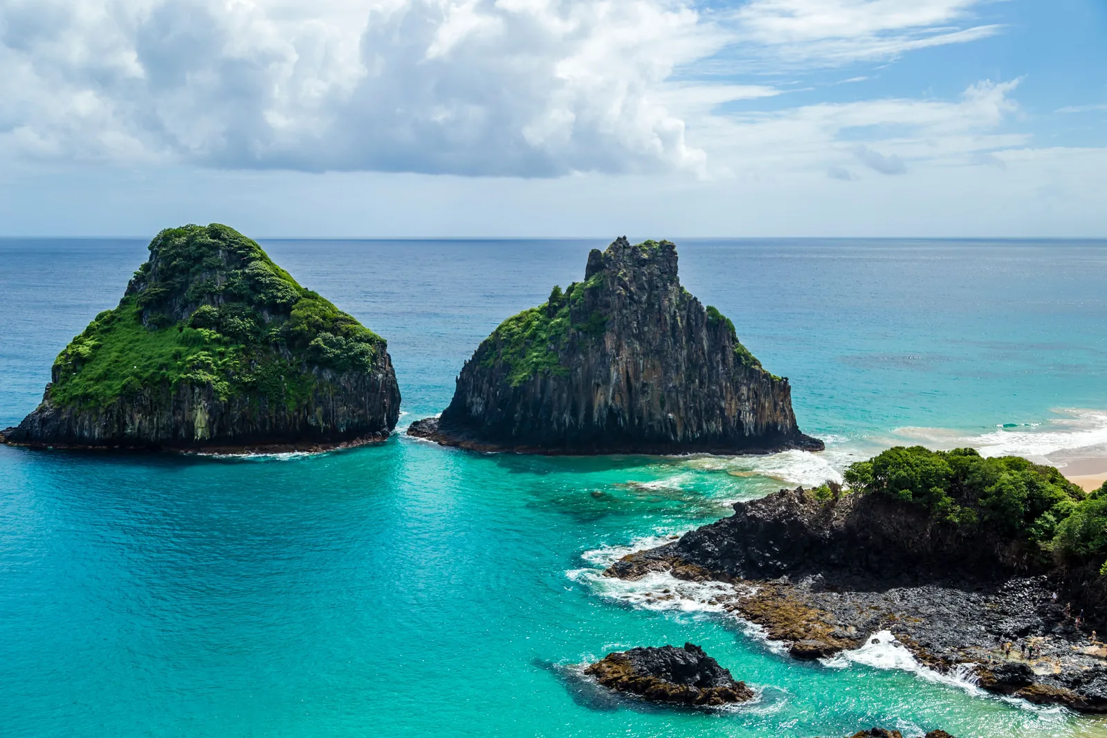 The Dois Irmãos rock formations rising from turquoise water in Fernando de Noronha, Brazil