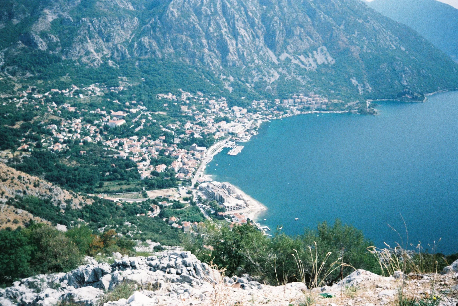 Aerial view of the Bay of Kotor and its coastal town surrounded by mountains, Montenegro