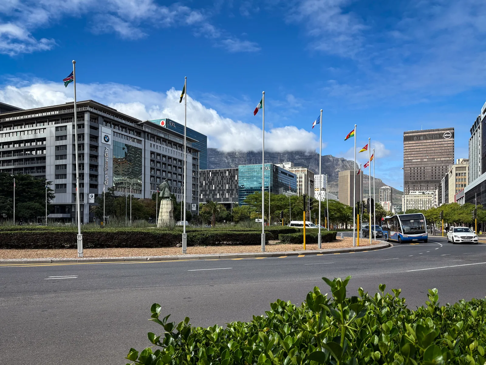 Cape Town city street with traffic, a bus and Table Mountain in the background