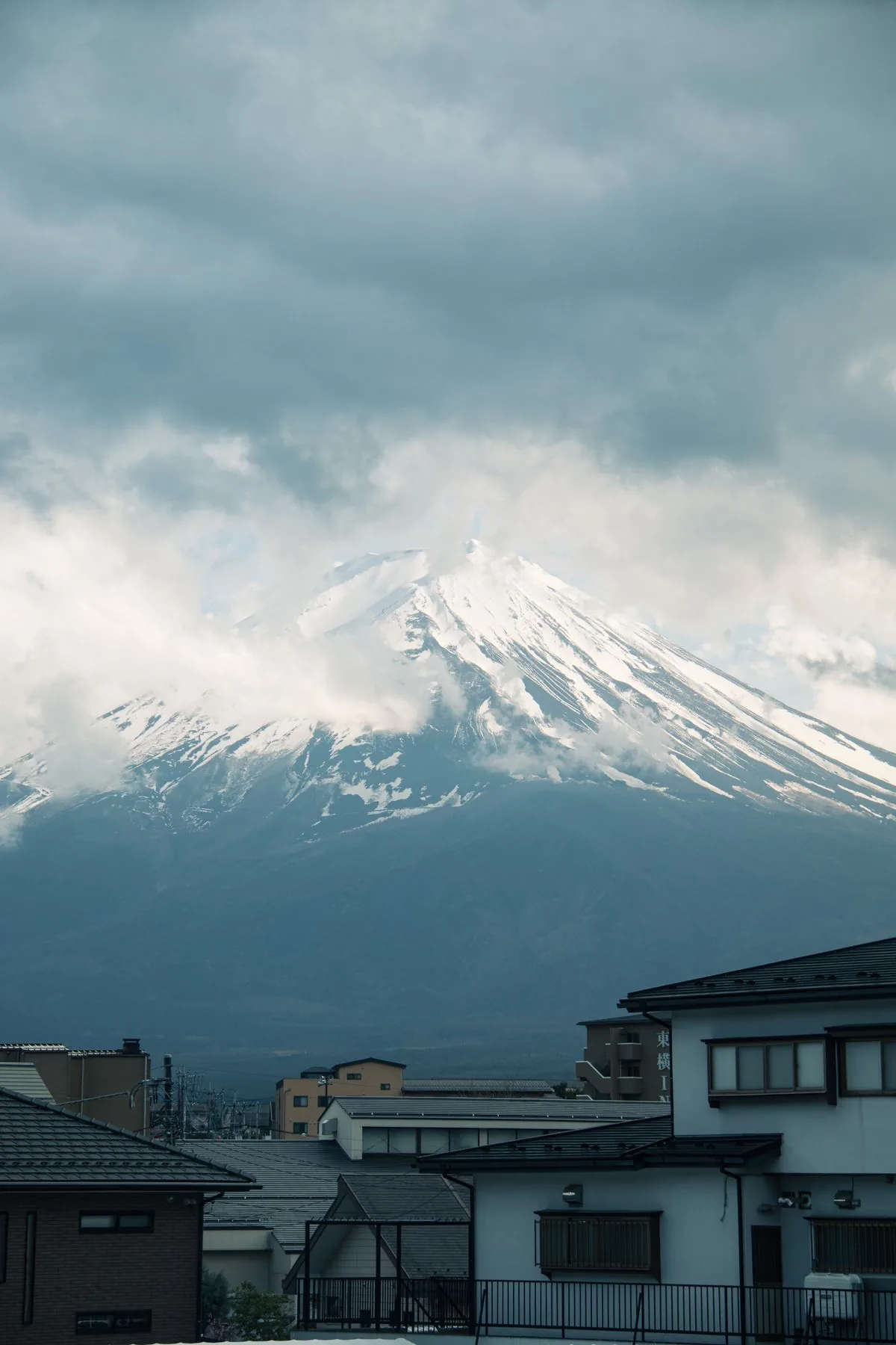 Mount Fuji rising behind a Japanese neighborhood