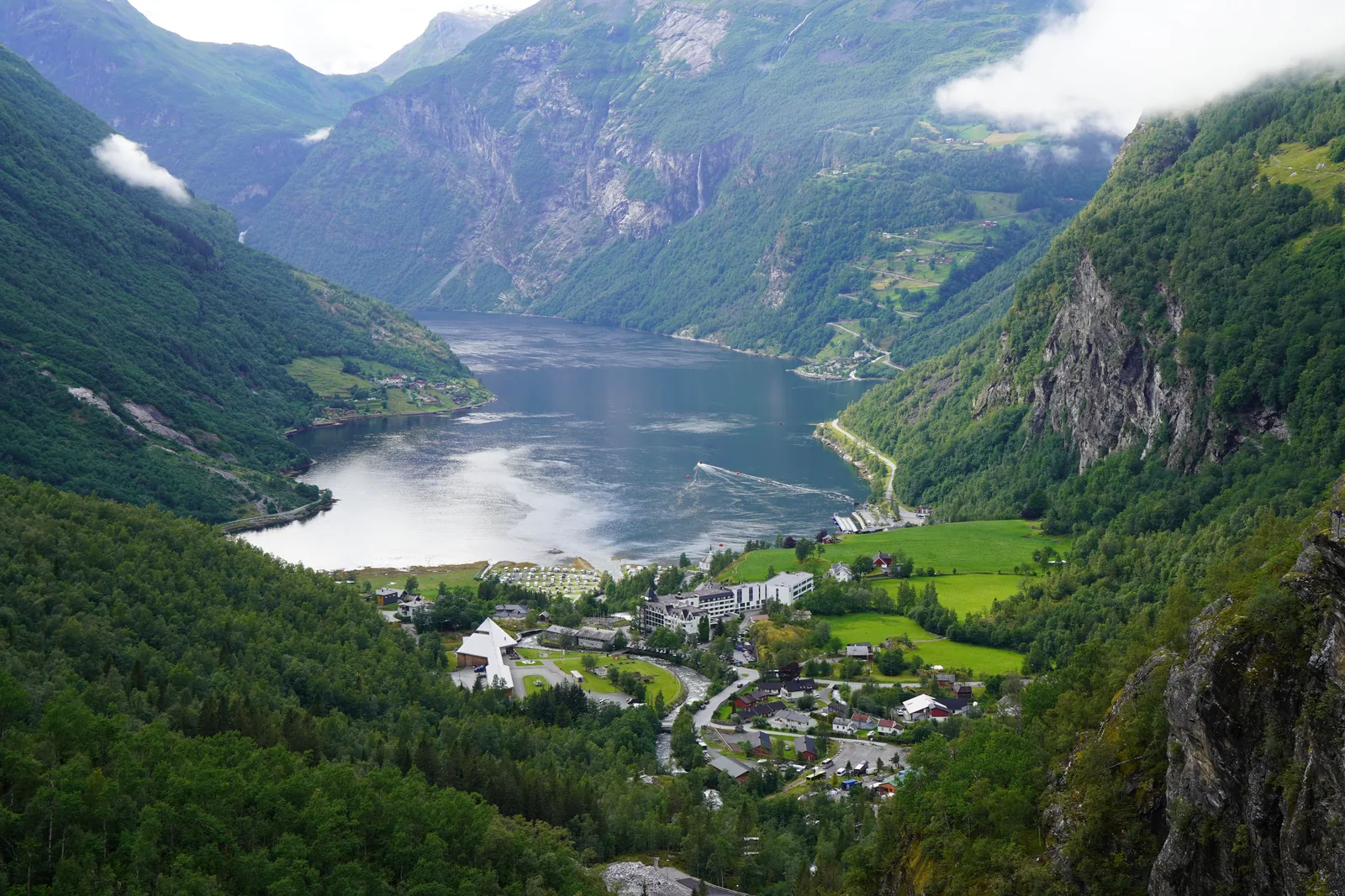 Aerial view of Geirangerfjord with green mountainsides and calm water, Norway