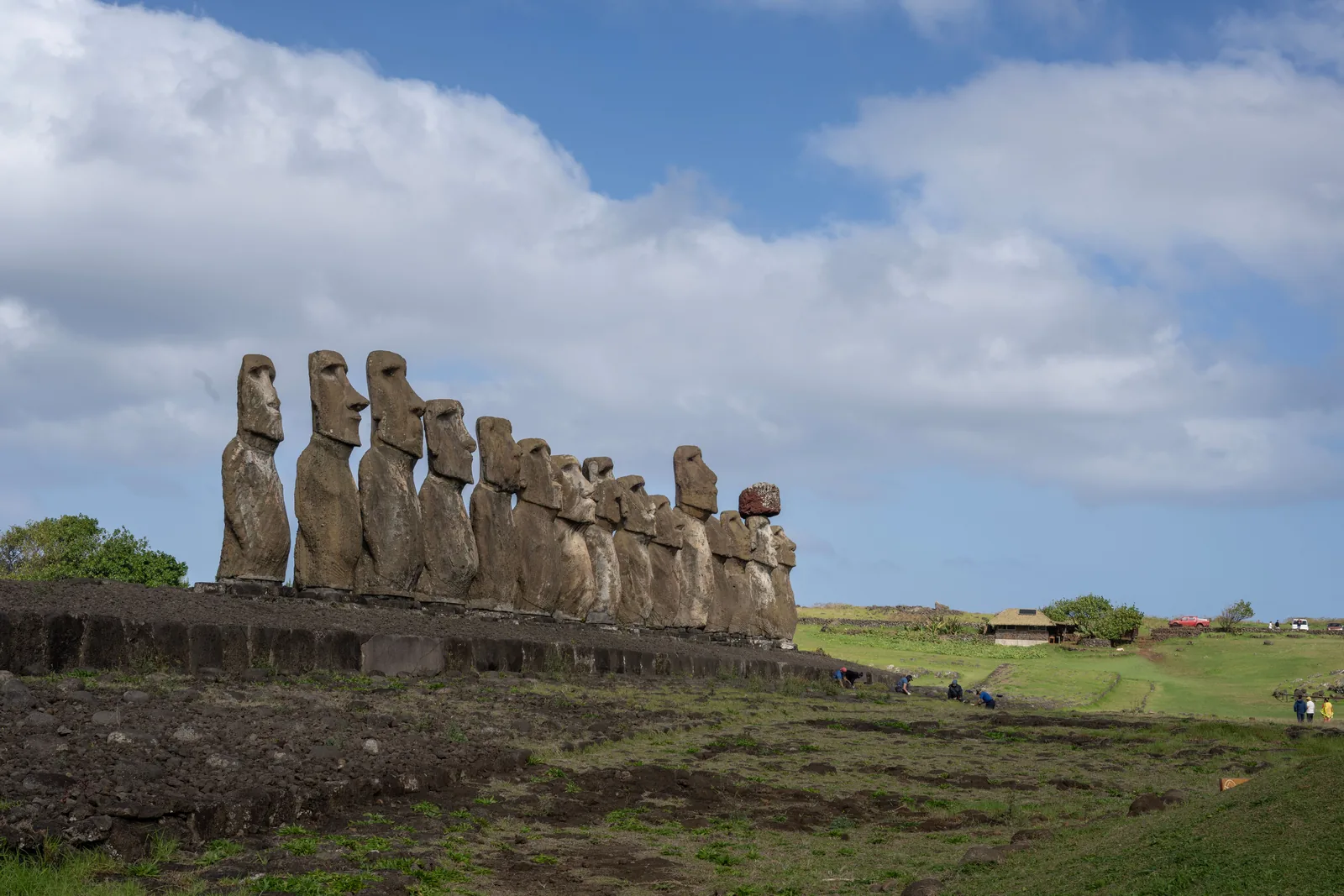 Row of moai statues at Ahu Tongariki under a blue sky, Easter Island, Chile