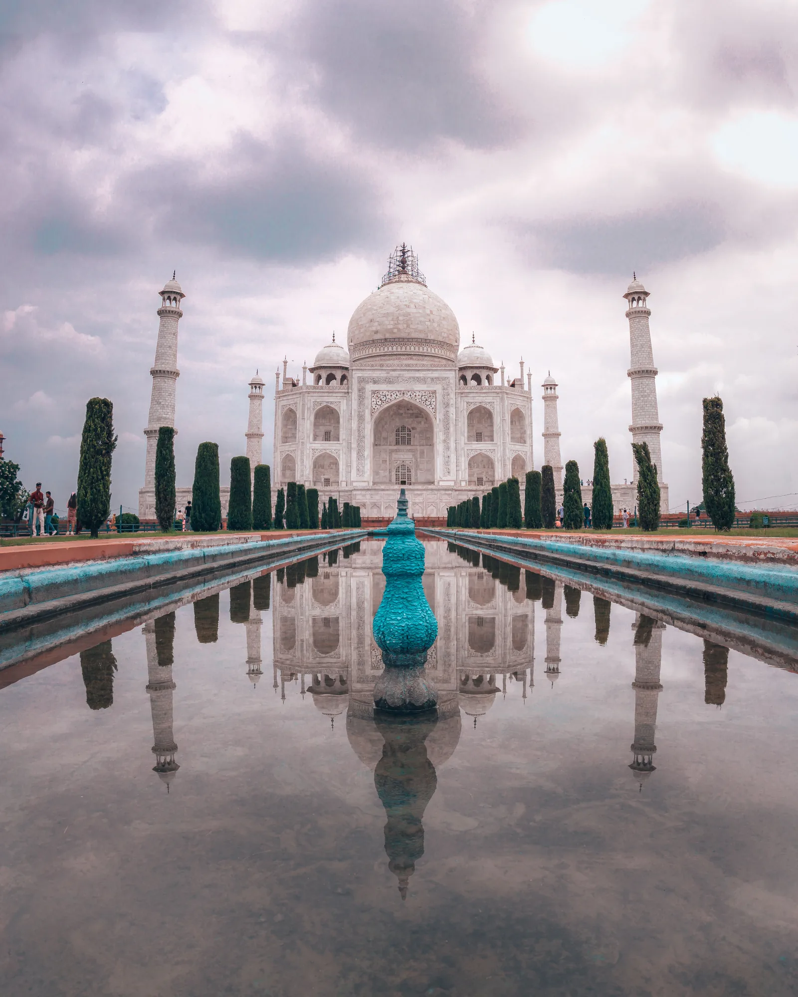 Symmetrical view of the Taj Mahal reflected in its long pool at sunrise, Agra