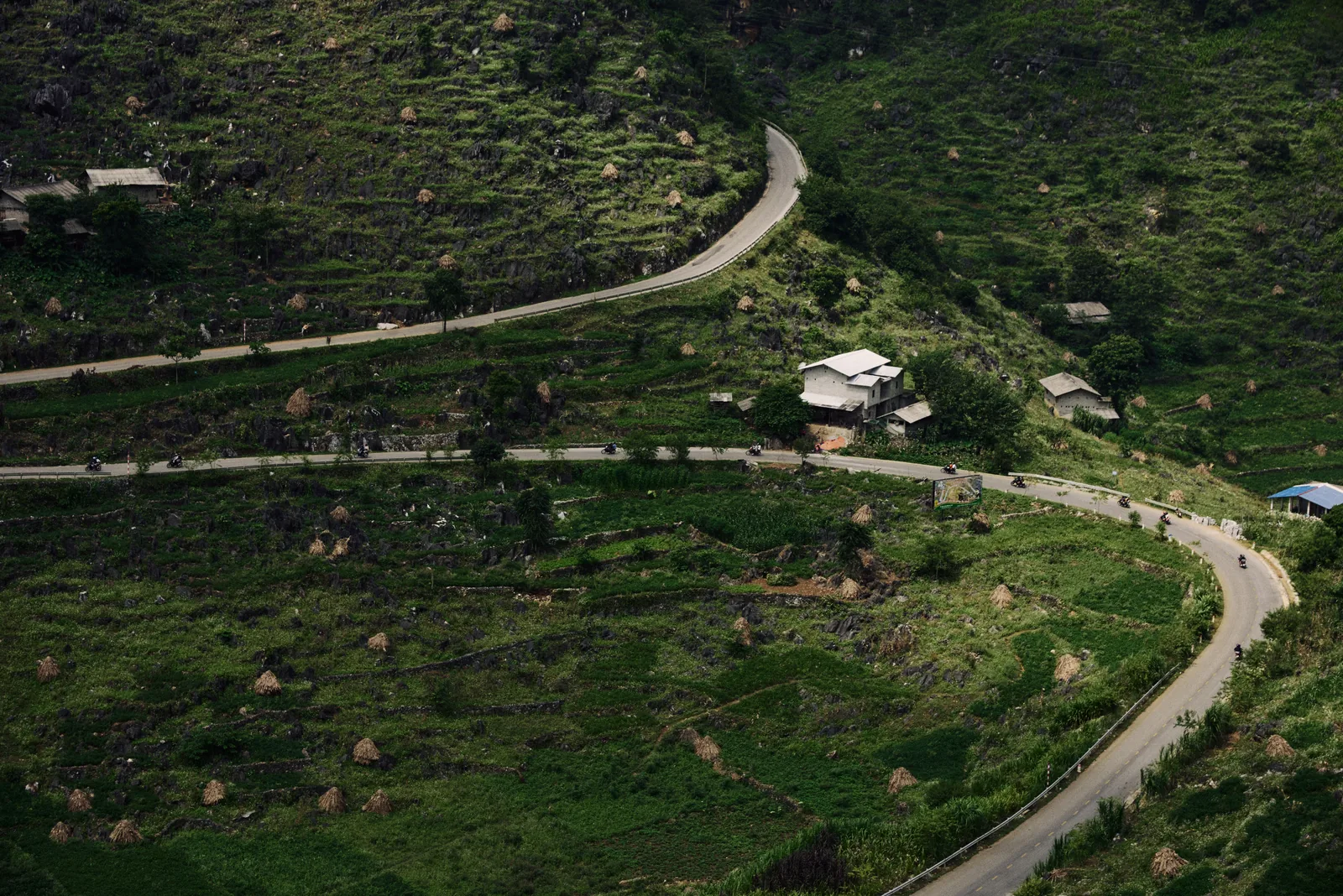 Winding mountain road through green terrain in Ha Giang, Vietnam