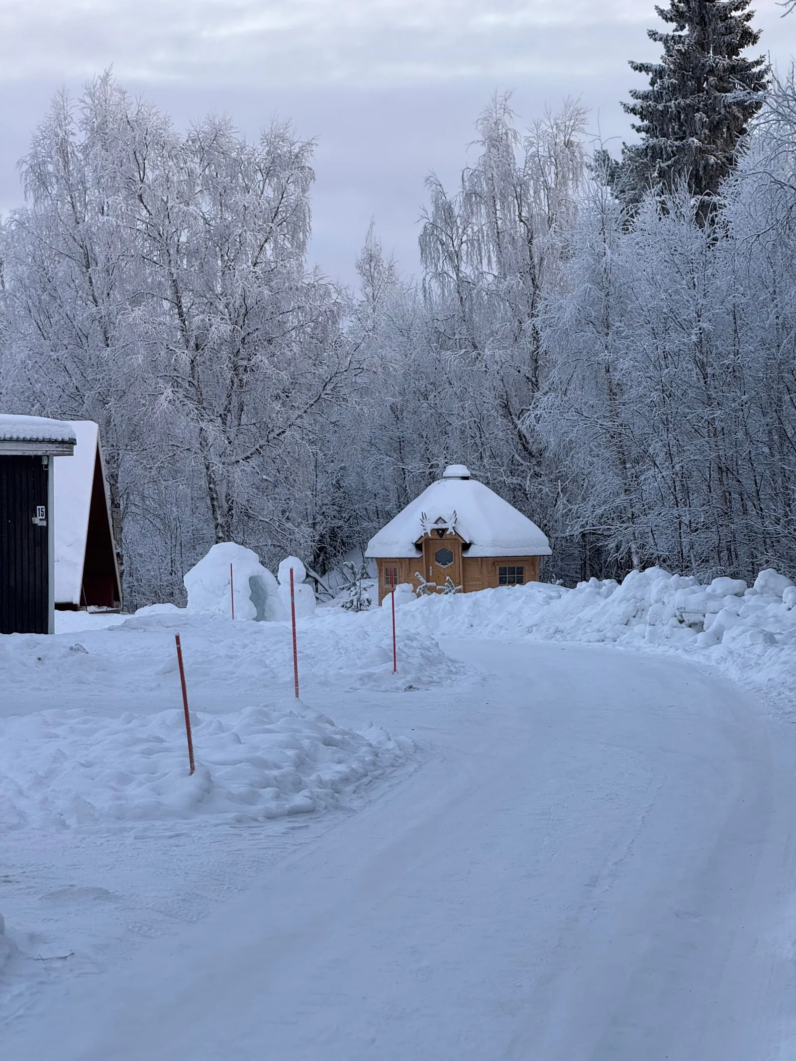 Snow-covered cabins and trees in Rovaniemi, Finnish Lapland