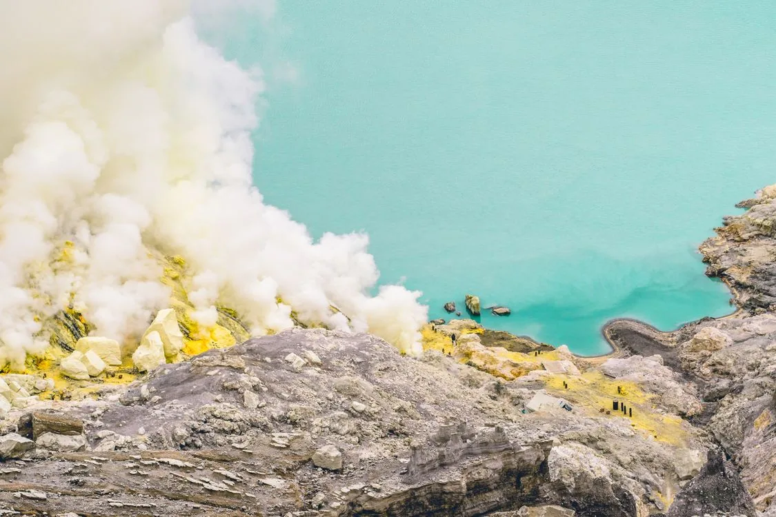 Aerial view of the turquoise crater lake and sulphur mine of Kawah Ijen, East Java