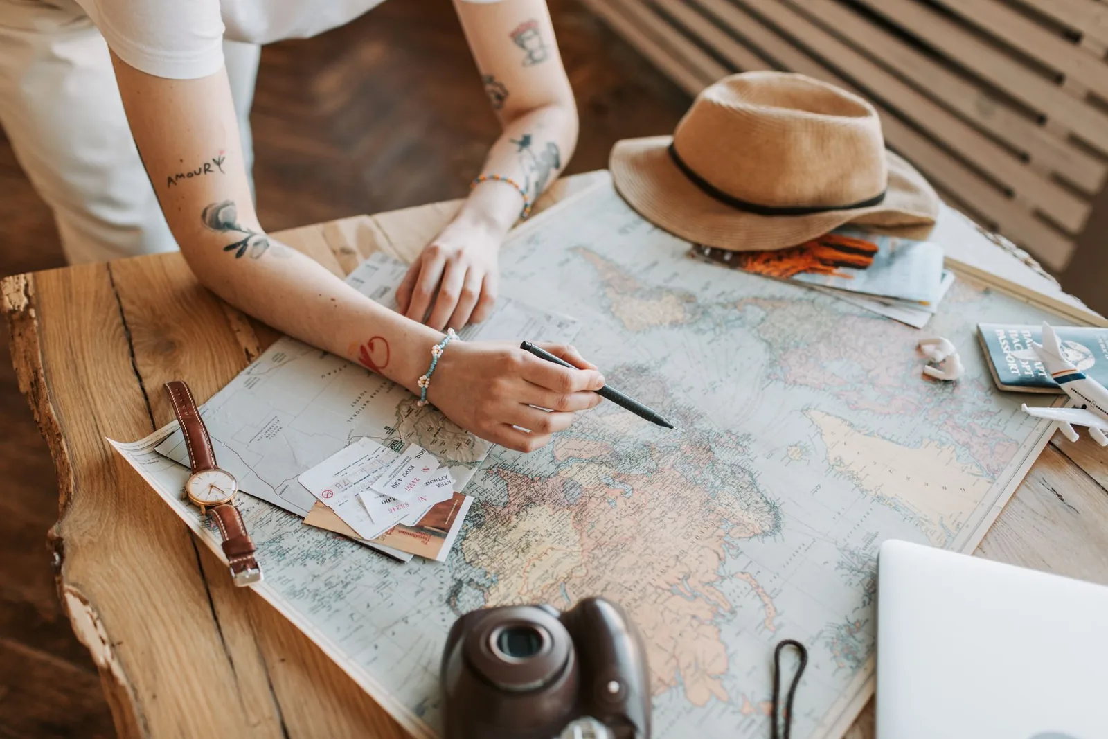 Traveler planning a journey with passports, a map and notebook